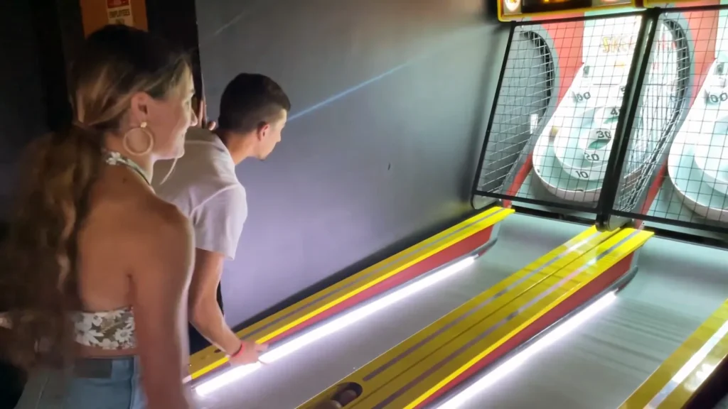 JoJo Crichton and Mel Breaux playing Skee-Ball