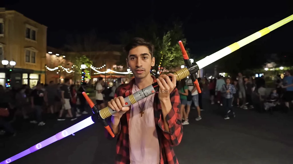 JoJo Crichton of JoJo's World holding a lightsaber and making a thumbnail at Disney's Hollywood Studios