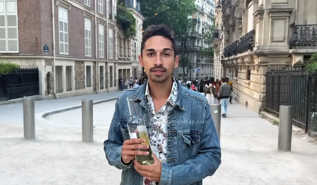JoJo Crichton holding bottle of wine during his first time in Paris. 
